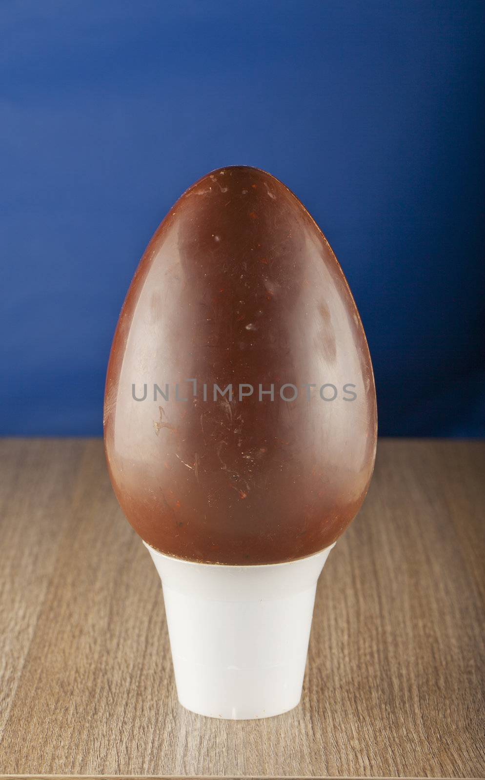 Entire Easter egg standing over a blue background