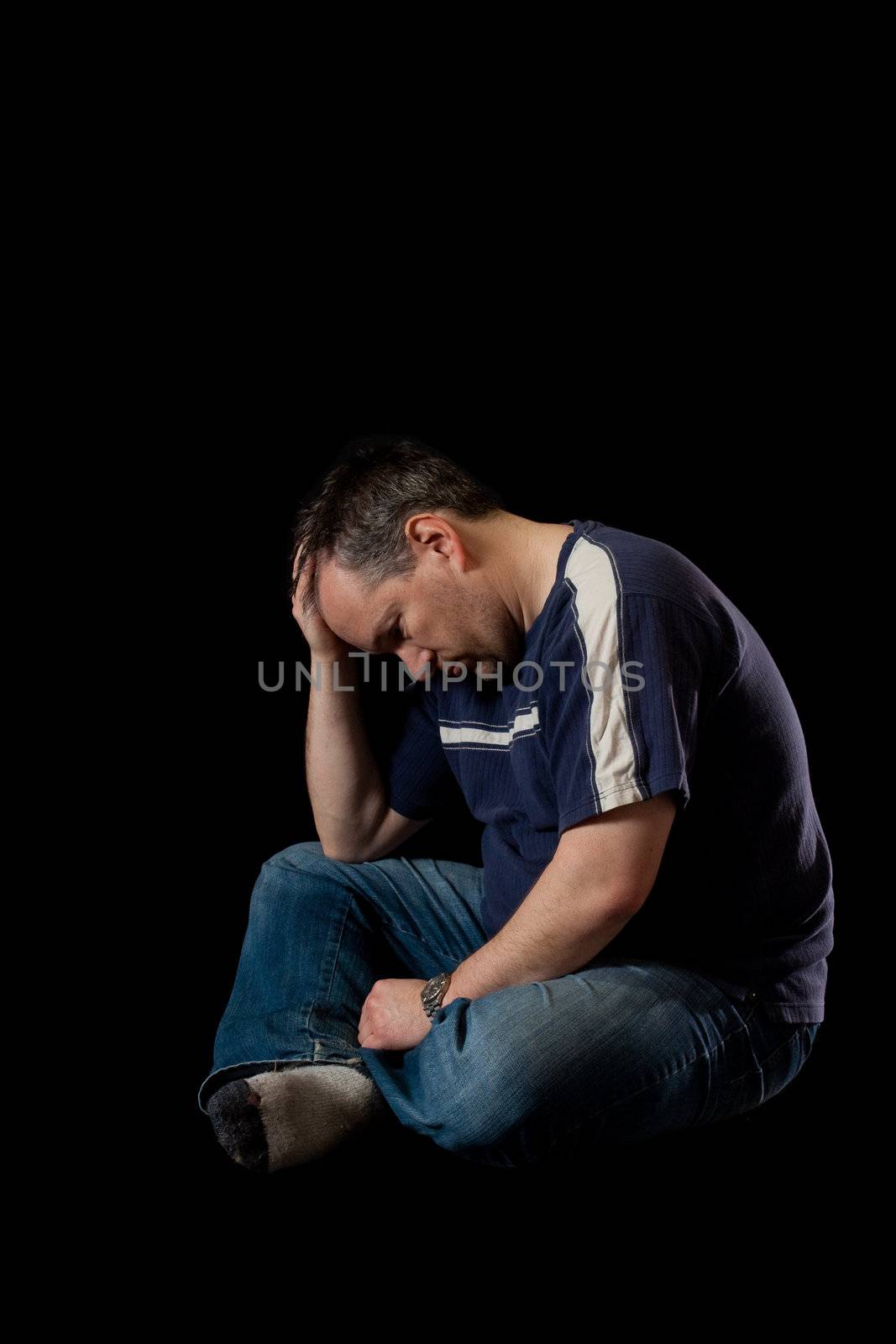 Depressed man on black background