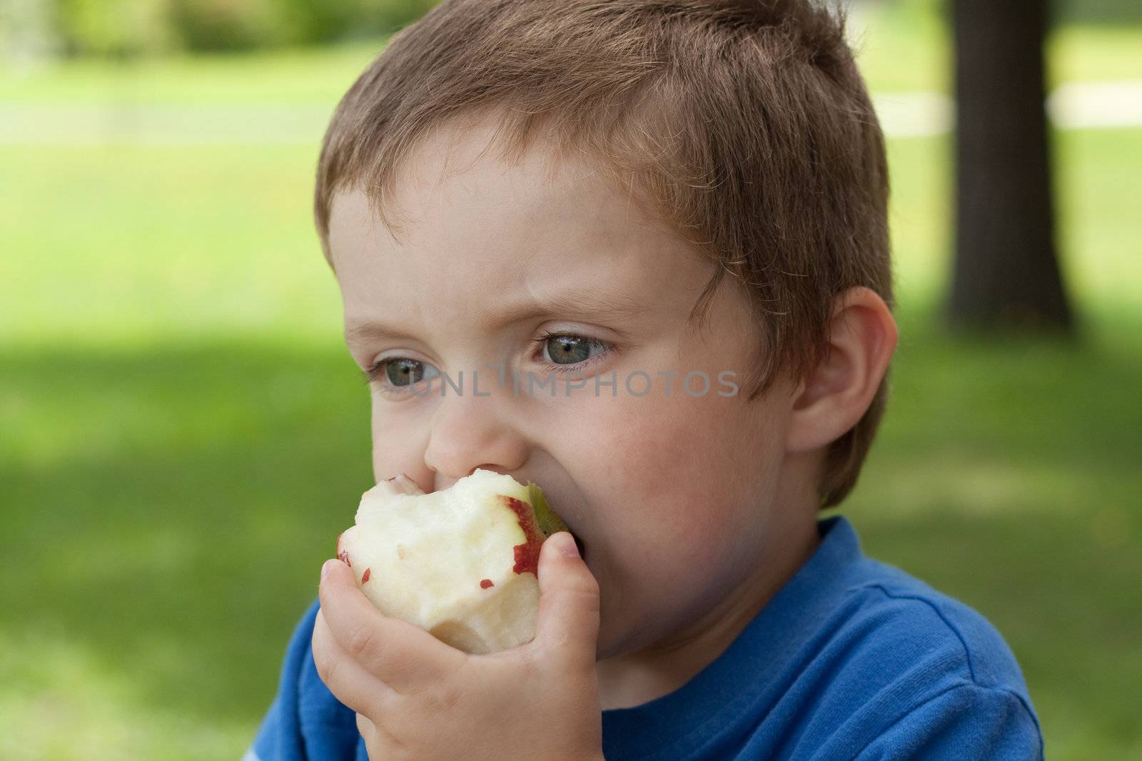 Boy eating an apple by Talanis