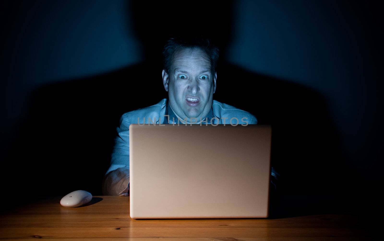 Man looking disgusted in front of his computer