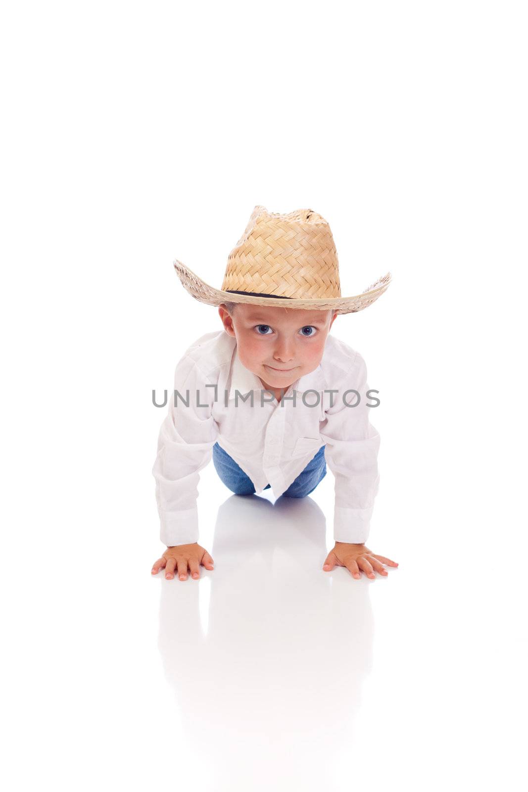 Little boy with a hat doing push-ups