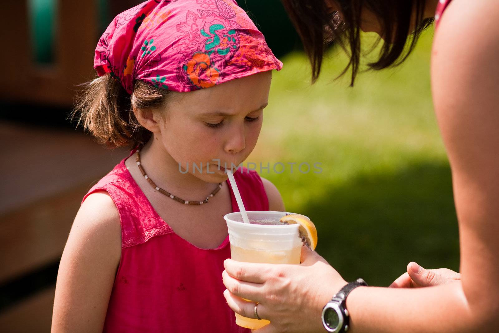 Girl with a glass of fresh lemonade