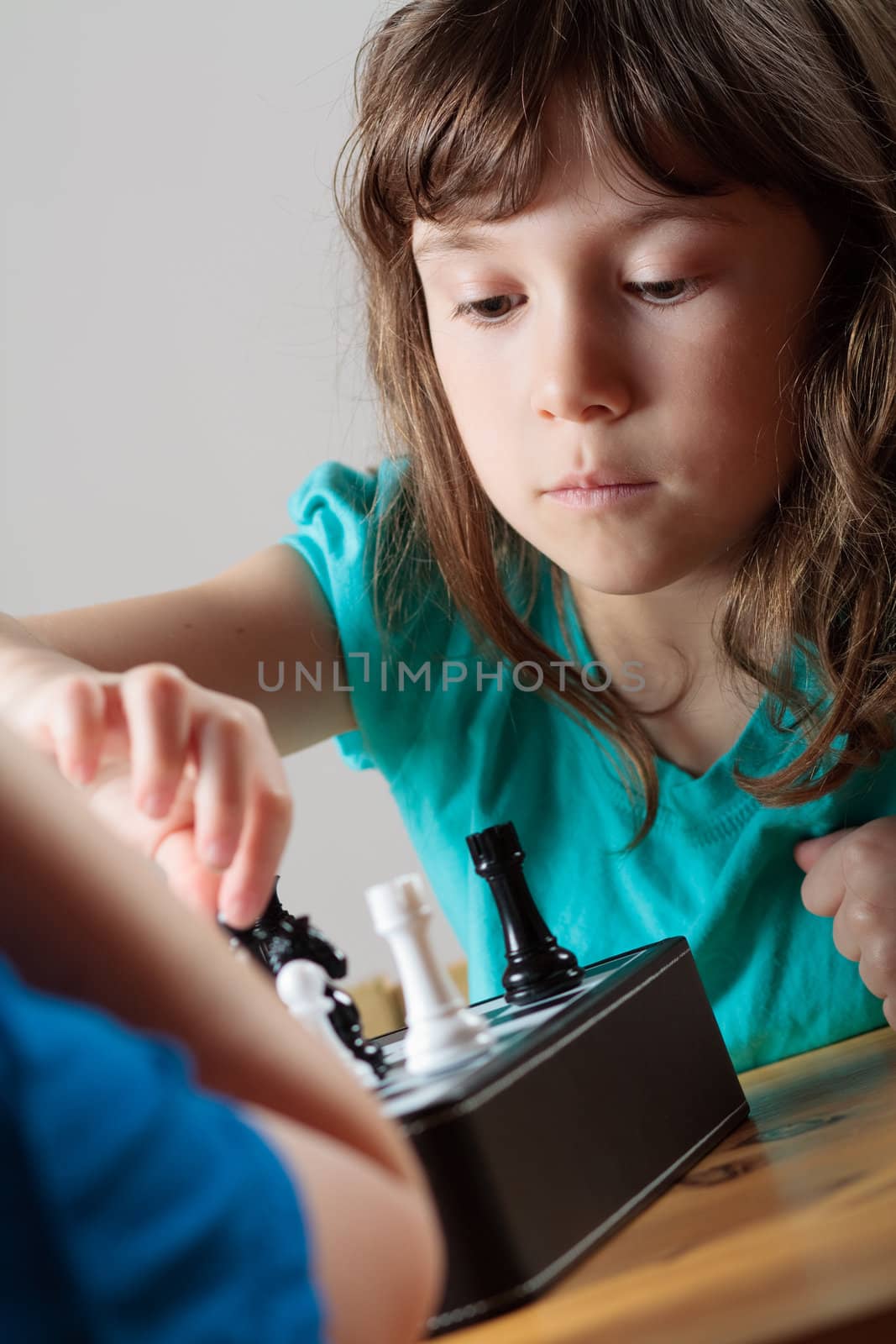 Cute little girl playing chess