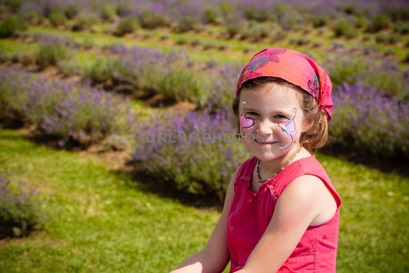 Cute little girl with make-up in a lavender field