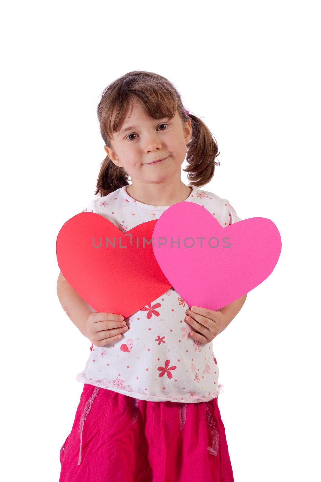 Cute little girl holding two hearts