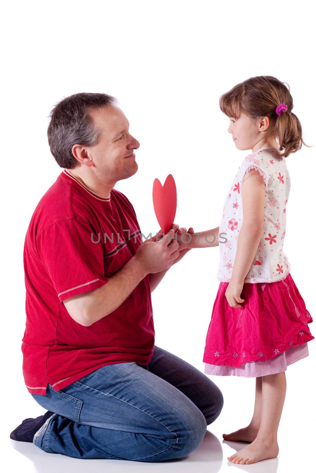 Cute little girl giving a Valentine to her dad