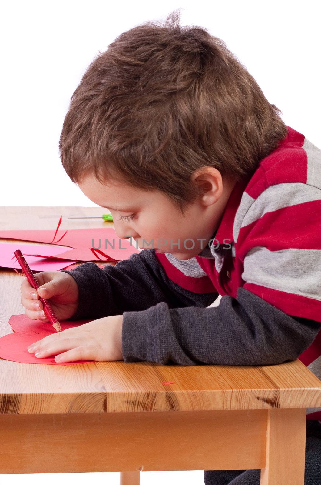Cute little children drawing on cardboard hearts
