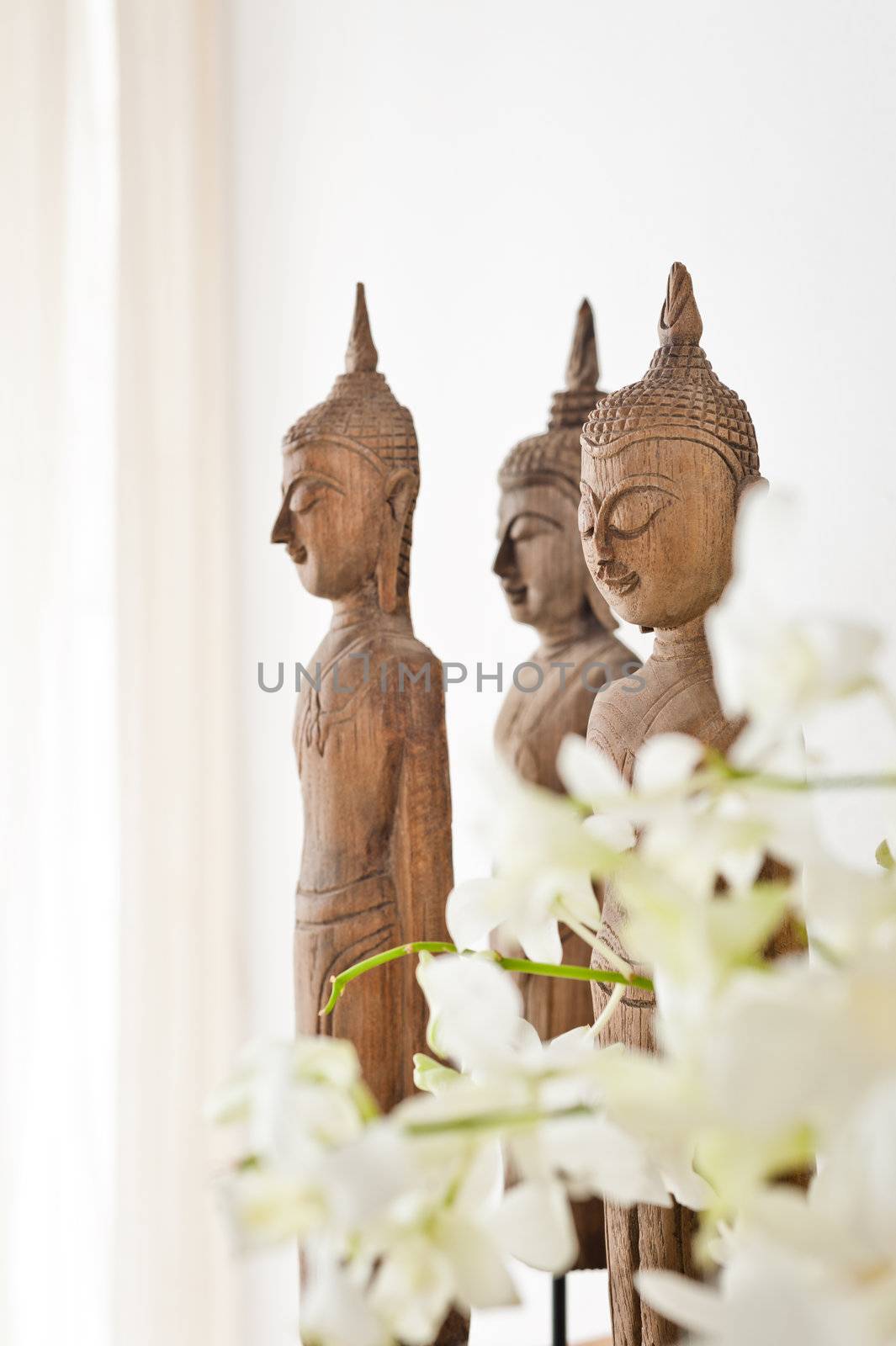 Buddha figurine in front of a white wall