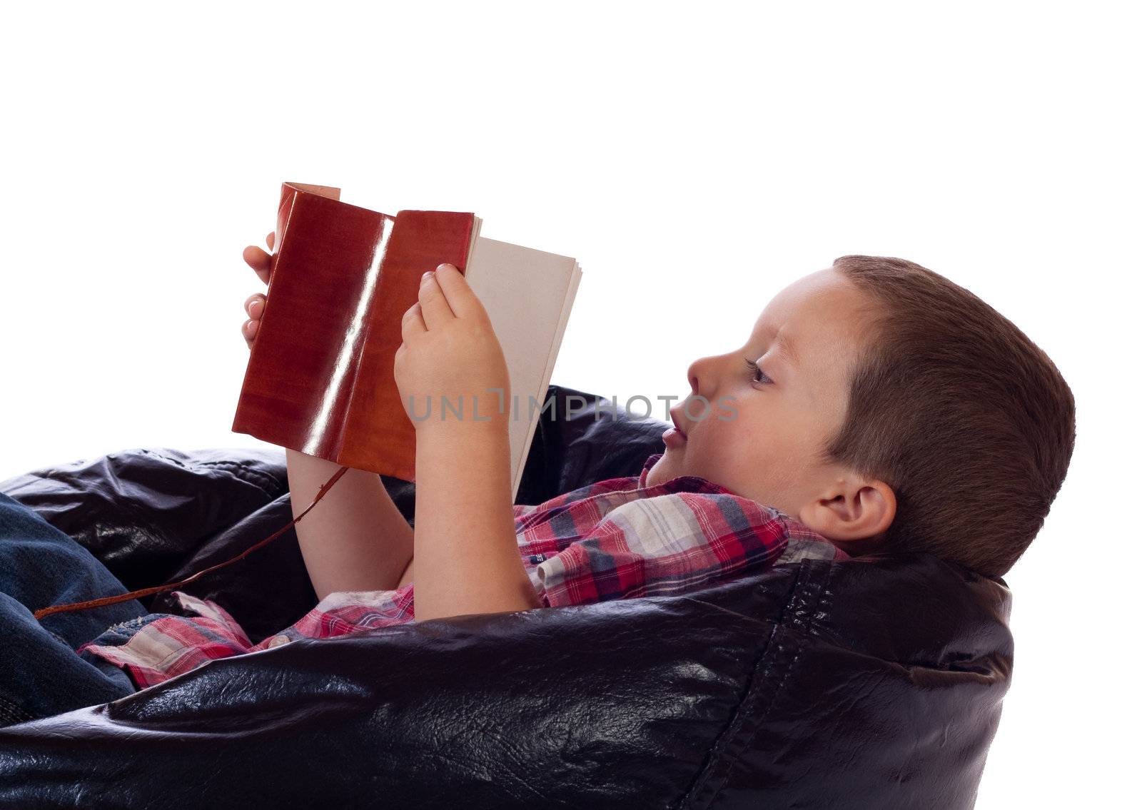 Cute little boy reading a vintage book