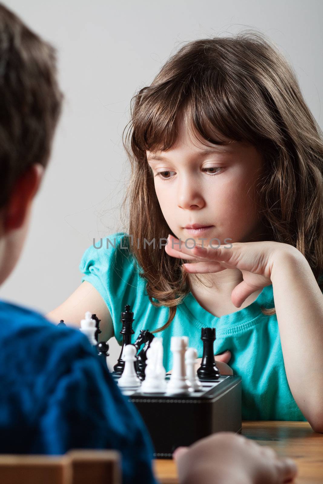 Girl and boy playing chess by Talanis