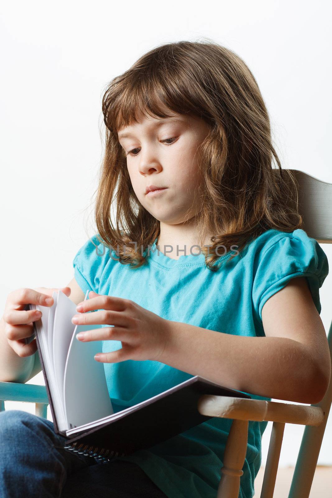 Cute little girl sitting and reading
