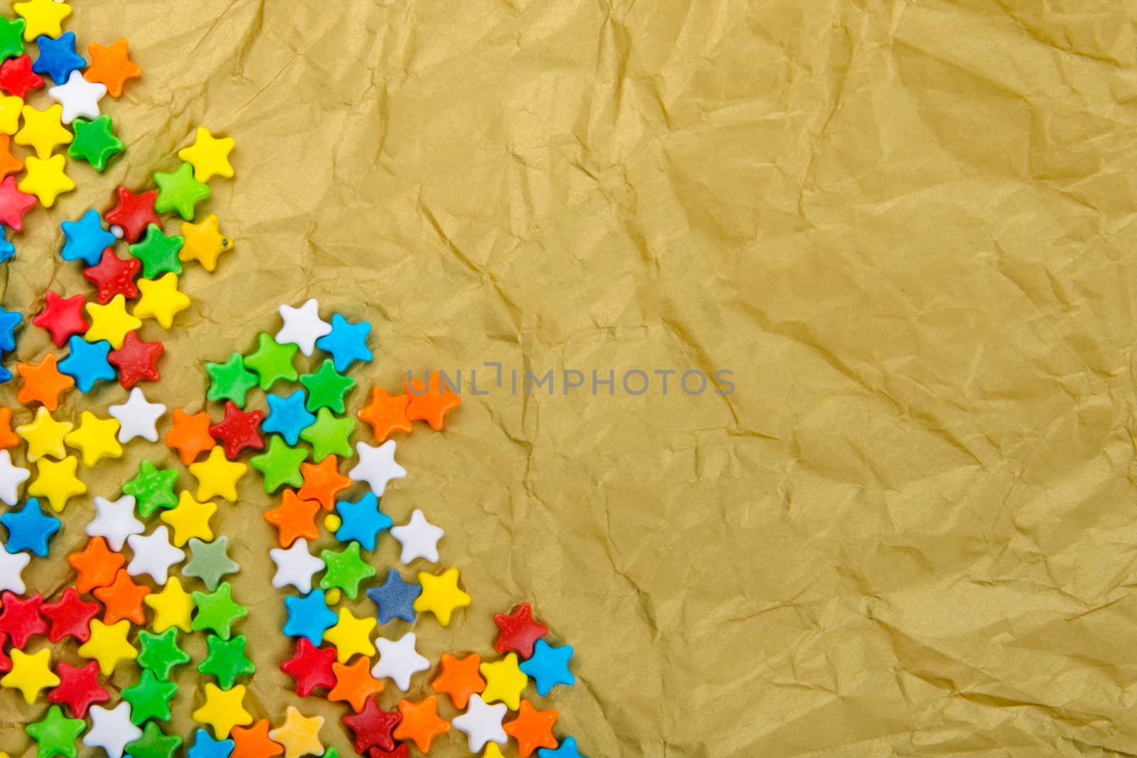 Multicolored stars on a background of crumpled paper