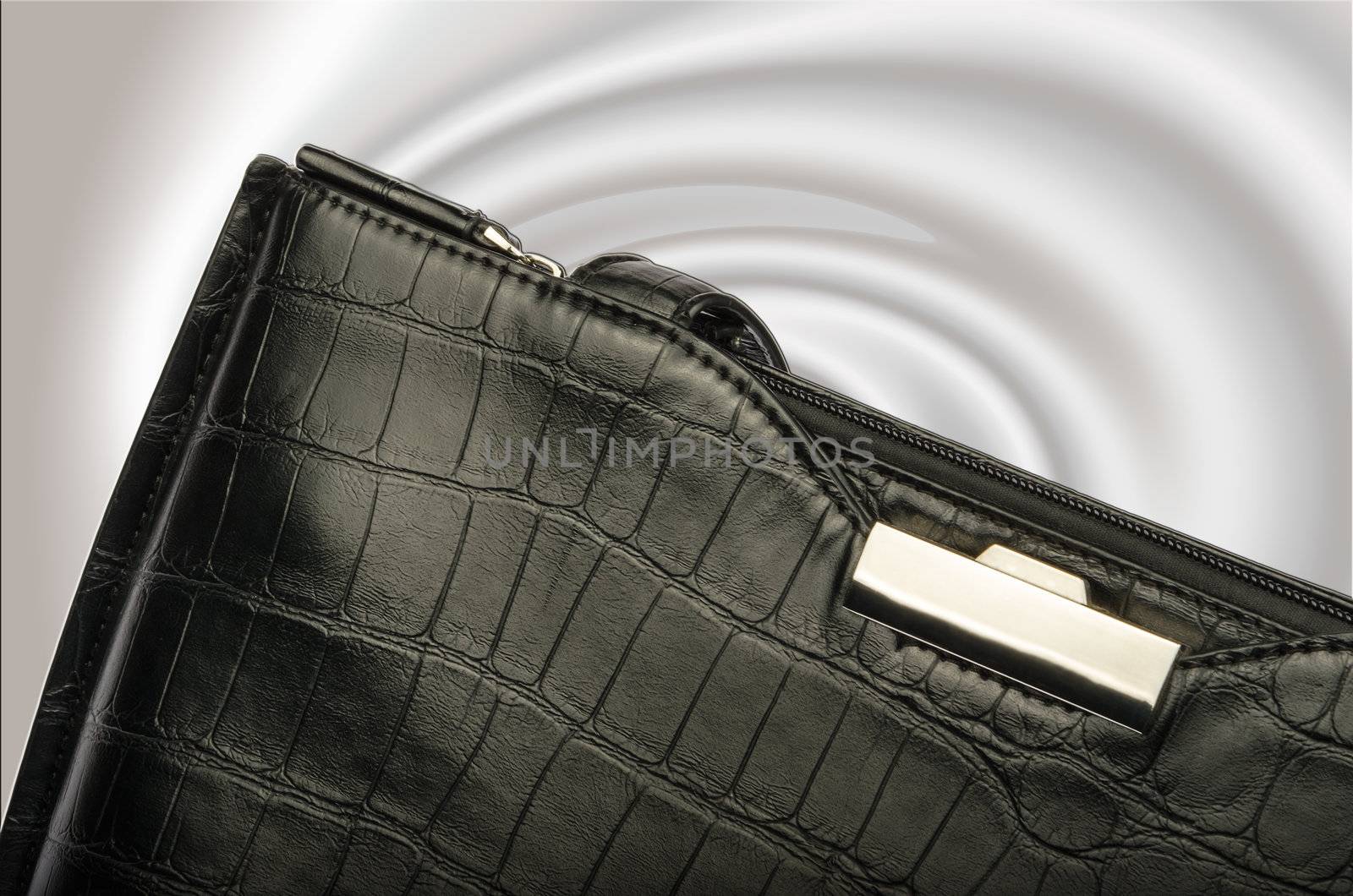 A black business handbag isolated on a graduated background