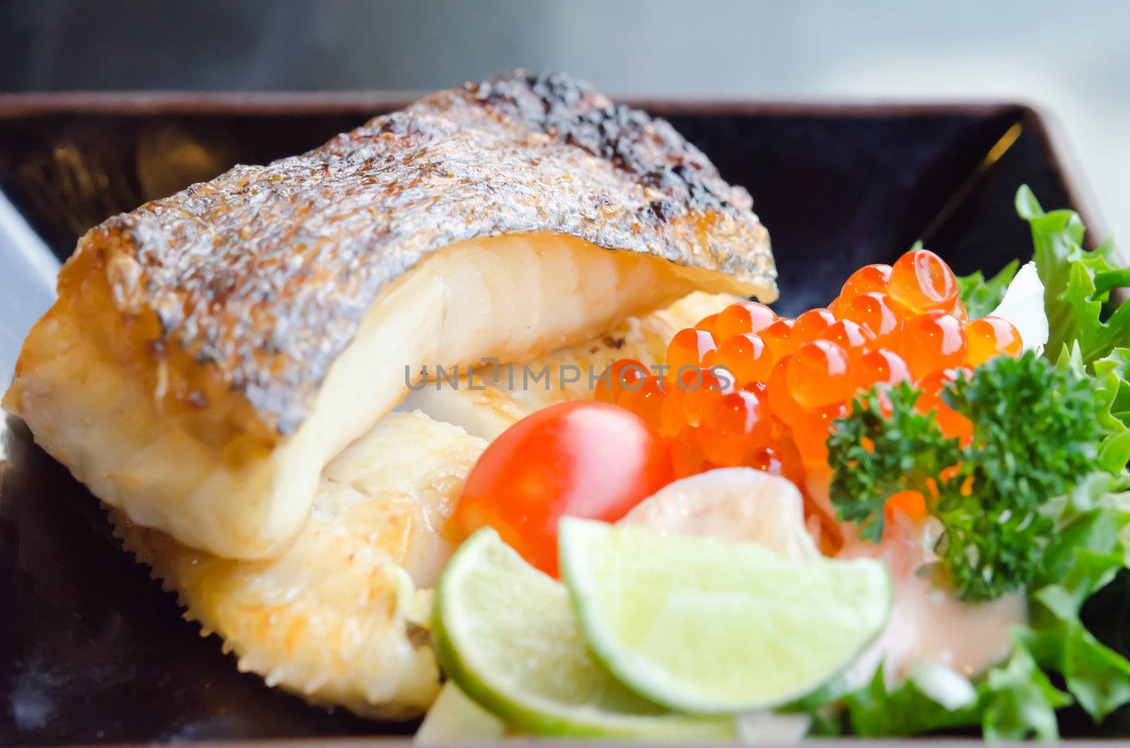fresh salad with fish egg  and Japanese grilled cod fish  on plate