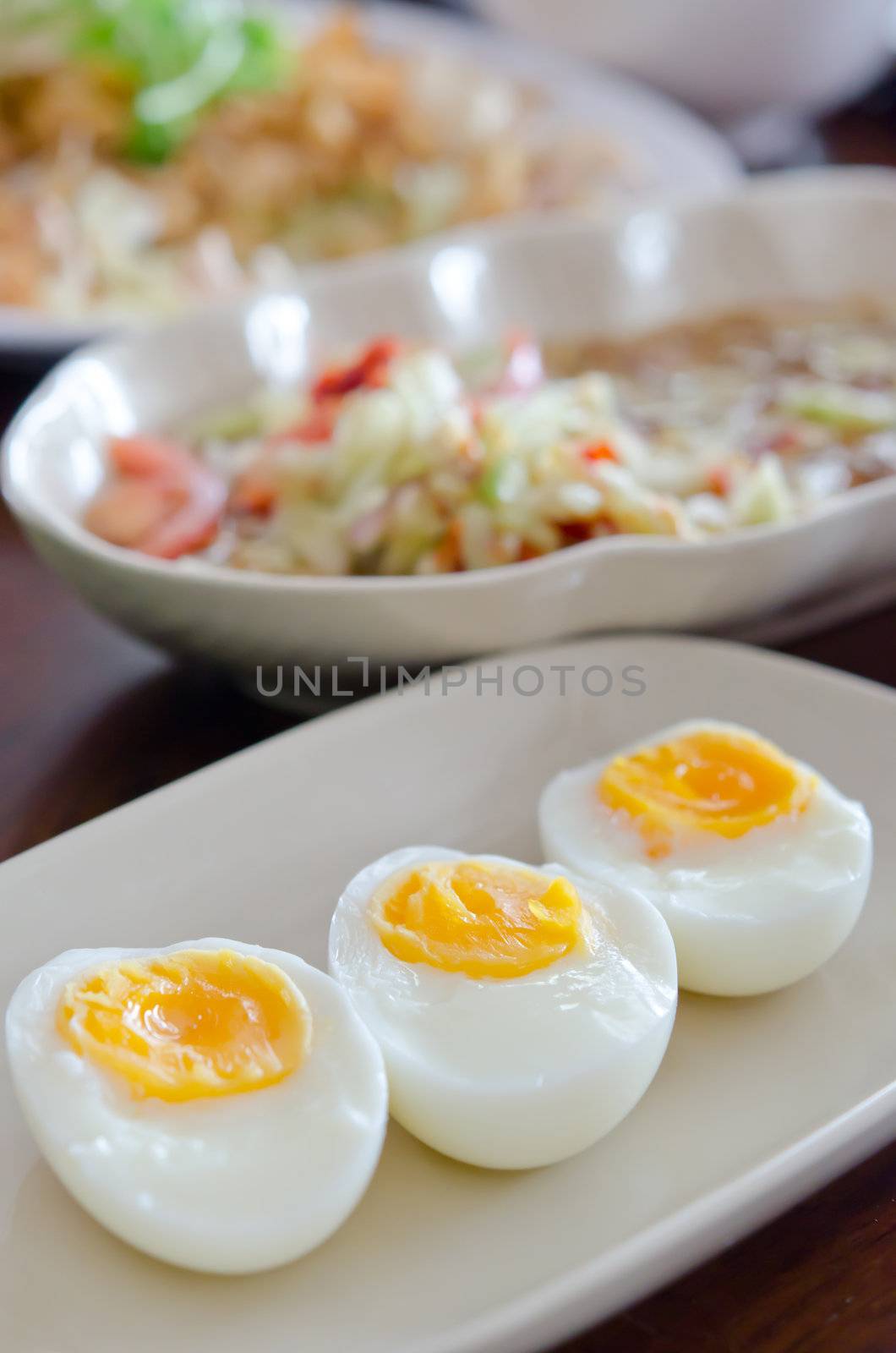 close up slice of boiled eggs on dish .