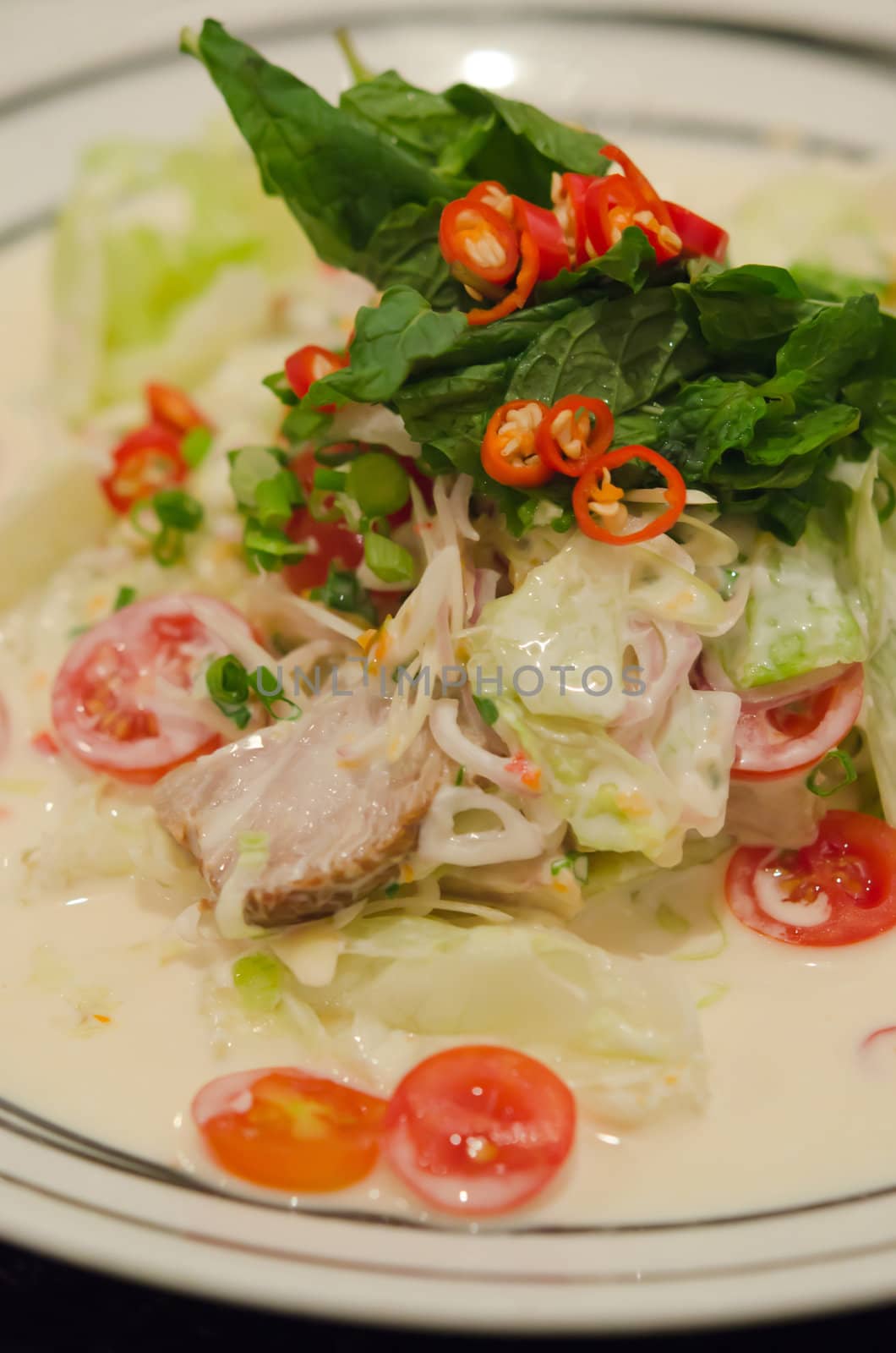 spicy  salad made with roasted pork and  fresh vegetable 