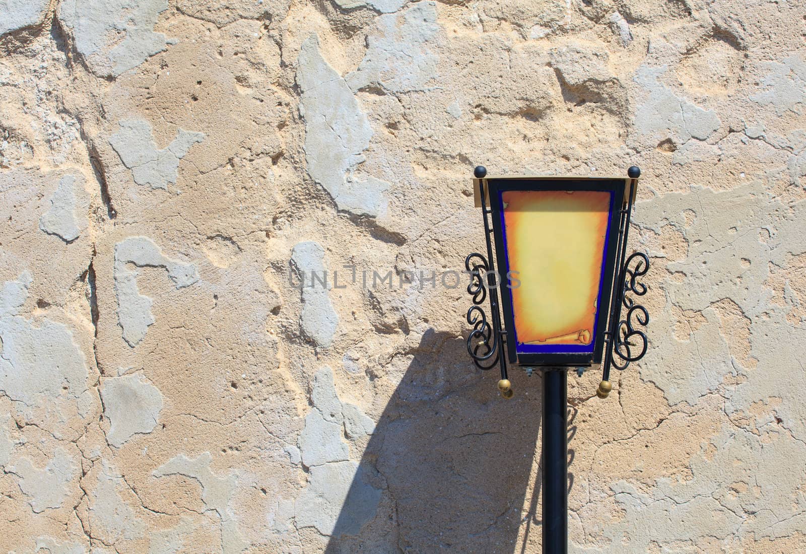 Photo of a old lantern on the dirty wall