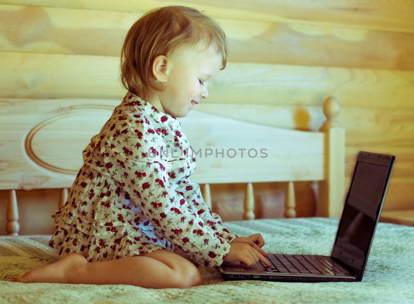 little girl is sitting at the computer by natochka