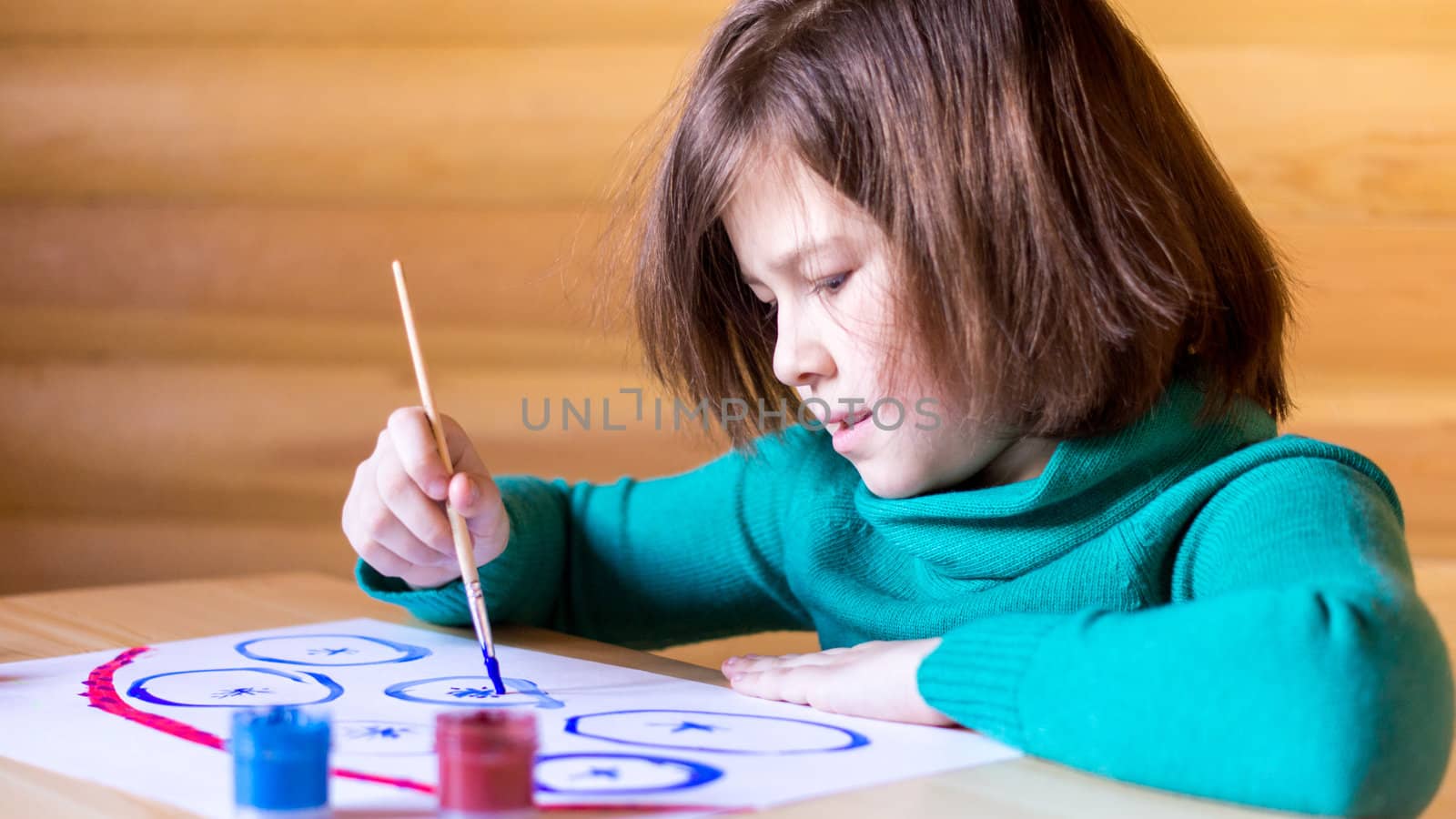 girl draws paints with enthusiasm