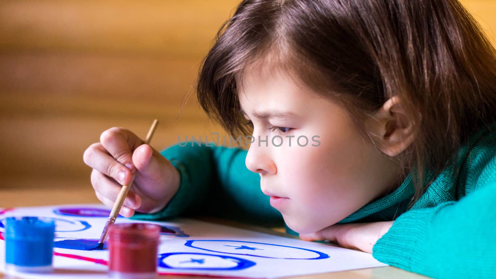 girl draws paints with enthusiasm