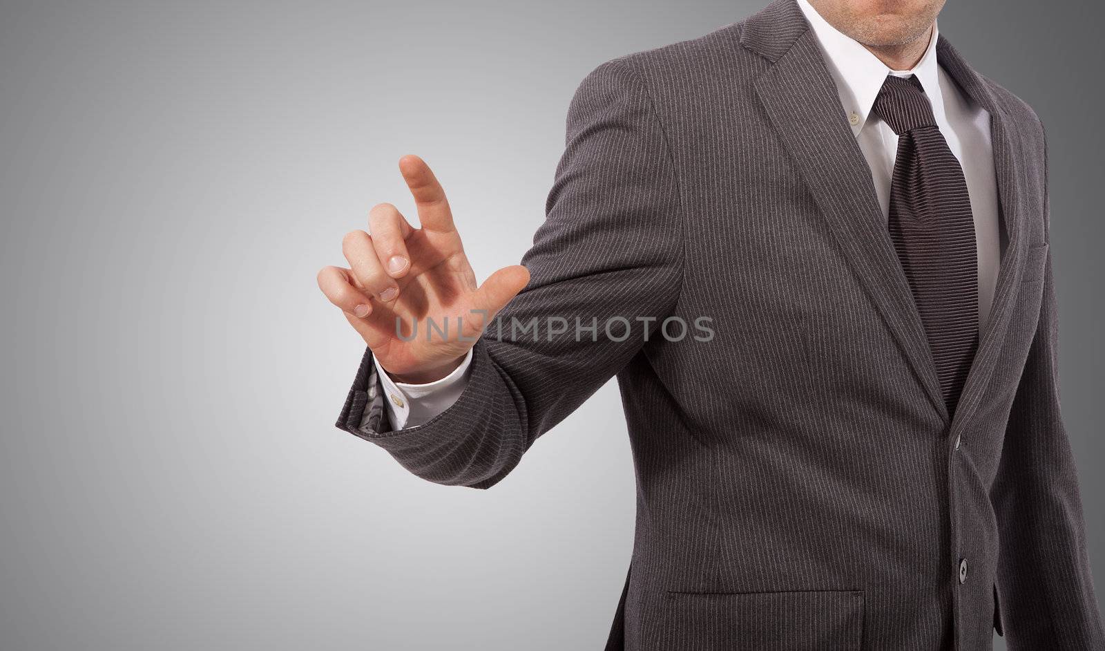 business man touching virtual screen, grey background