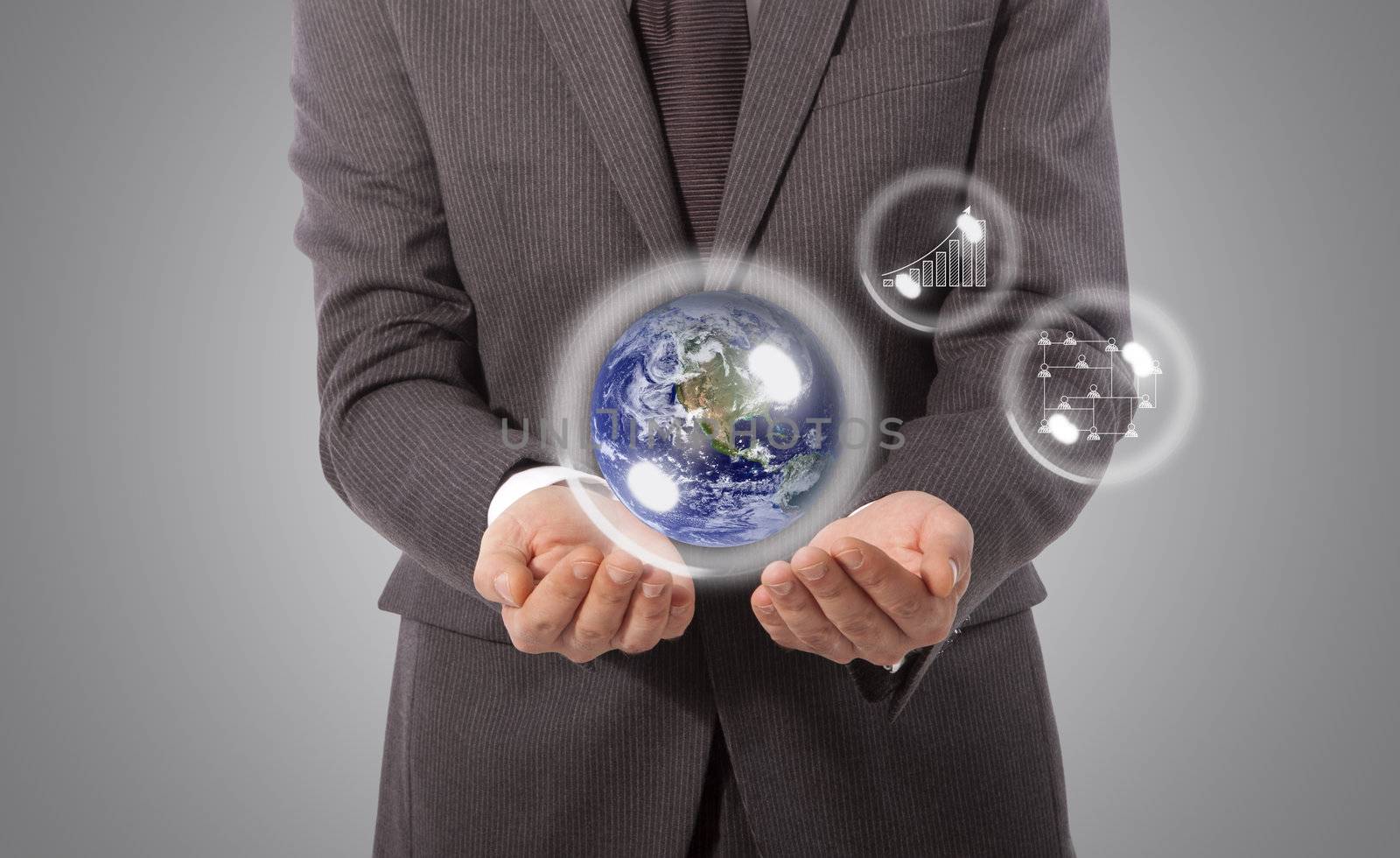 business man with earth globe in his hand, grey background