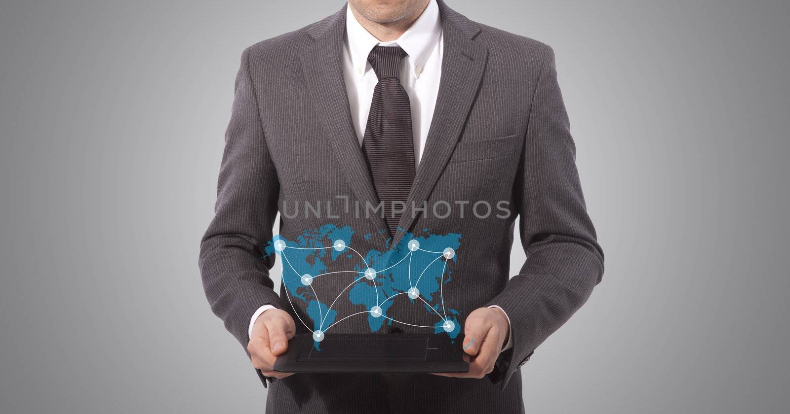 business man with touch tablet in hands, grey background. world map from www.lib.utexas.edu