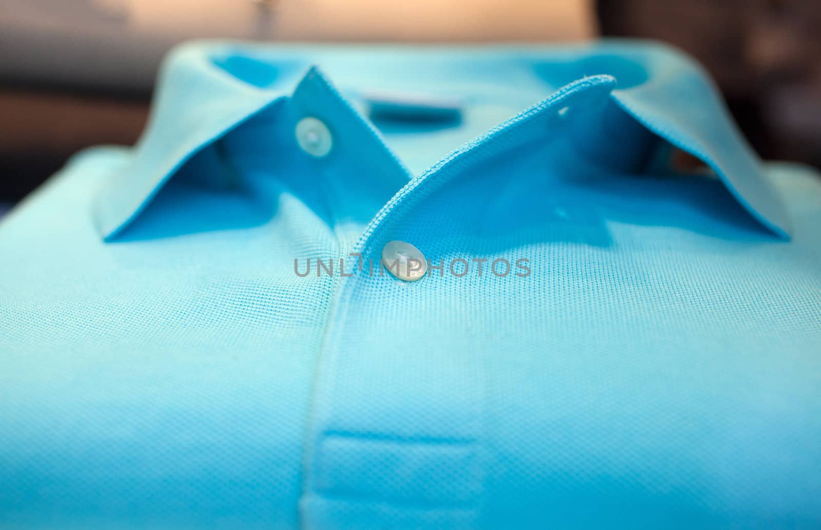 Photo of cyan Shirt poloin a clothes shop