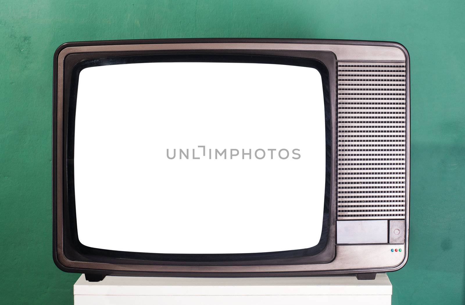 Old television, green wall on the background