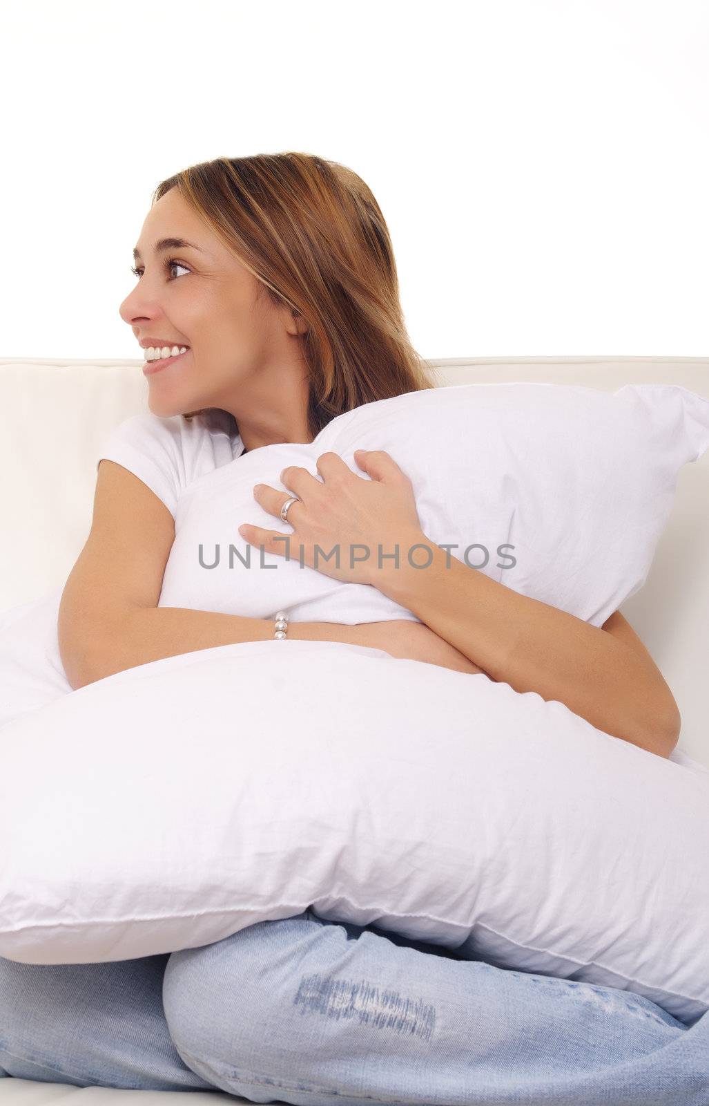 mature lady cuddling a pillow on couch