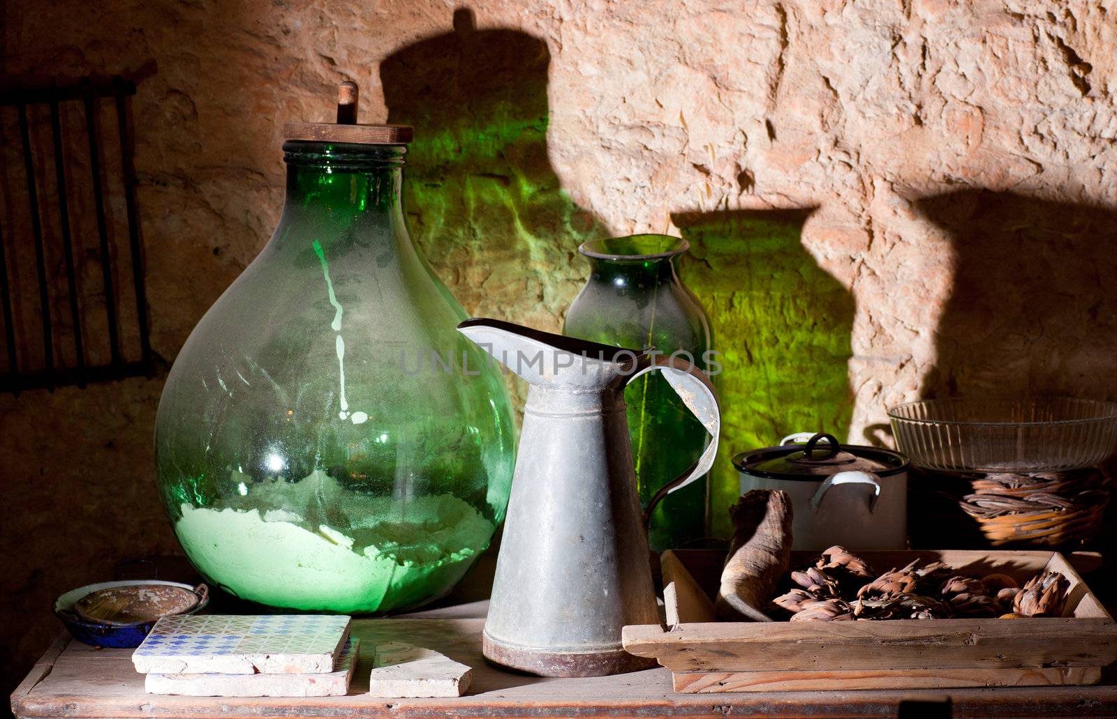 Photo of an iron pitcher and glass demijohn