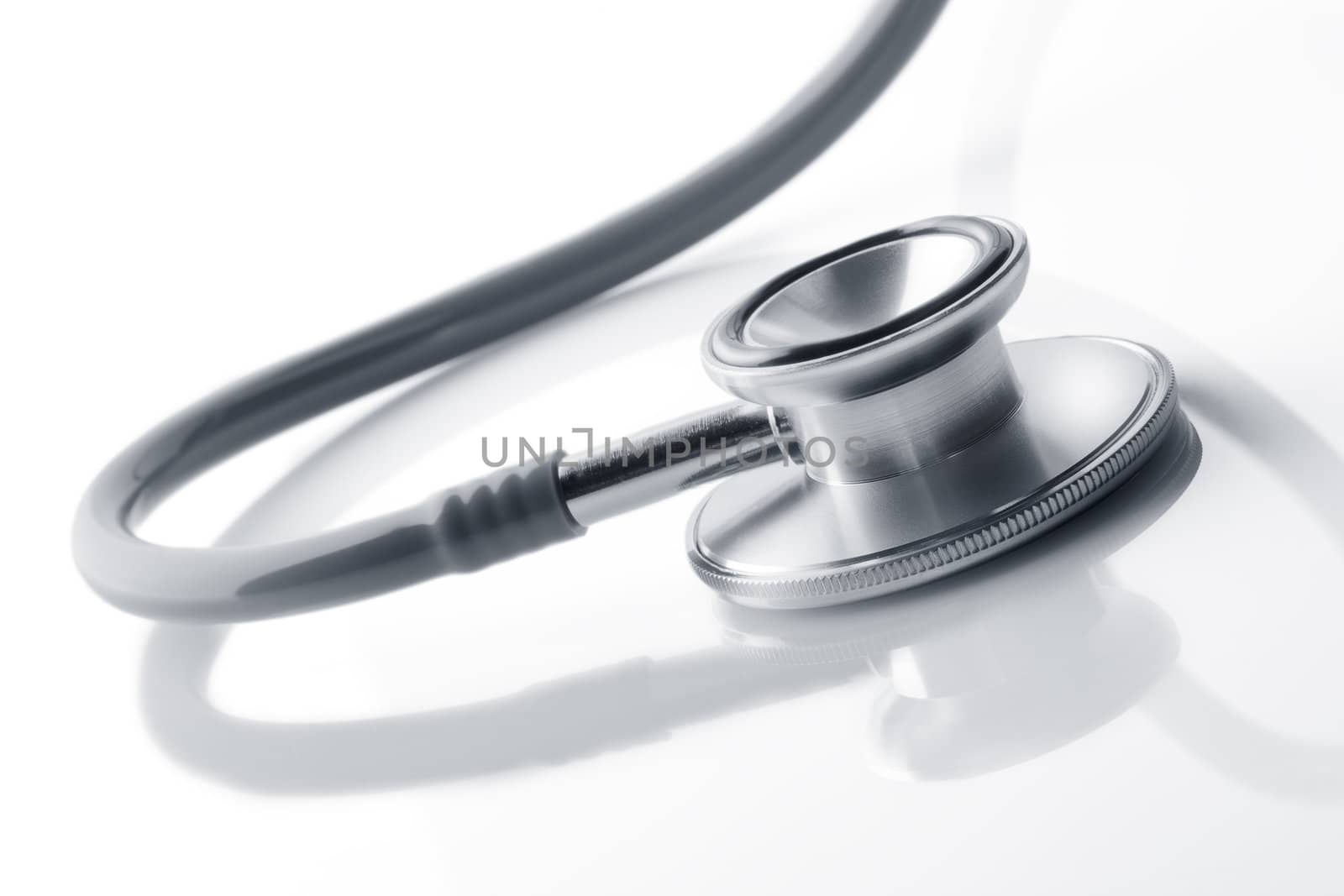 Close up view of grey stethoscope on white back