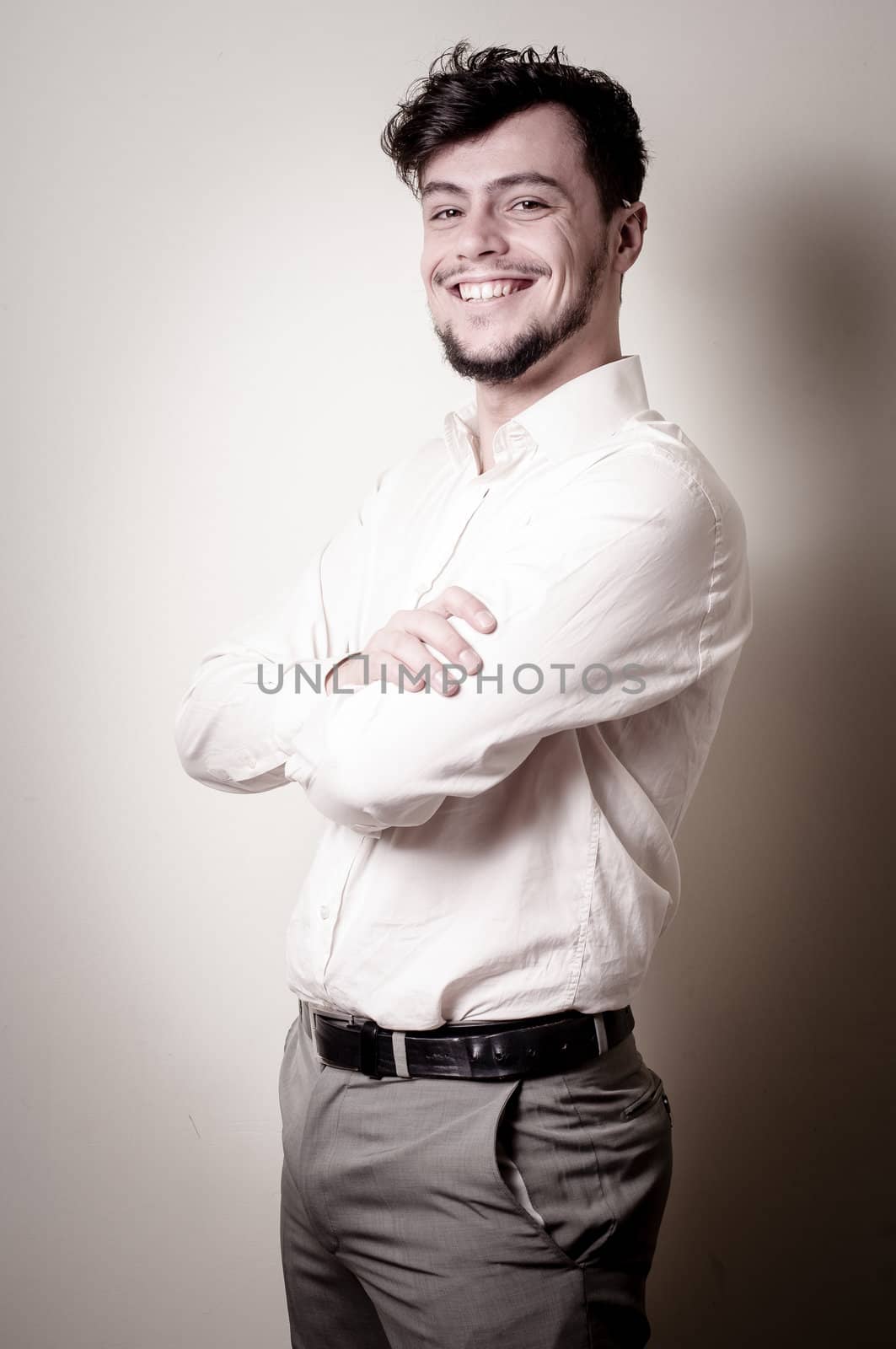 stylish modern guy with white shirt on gray background