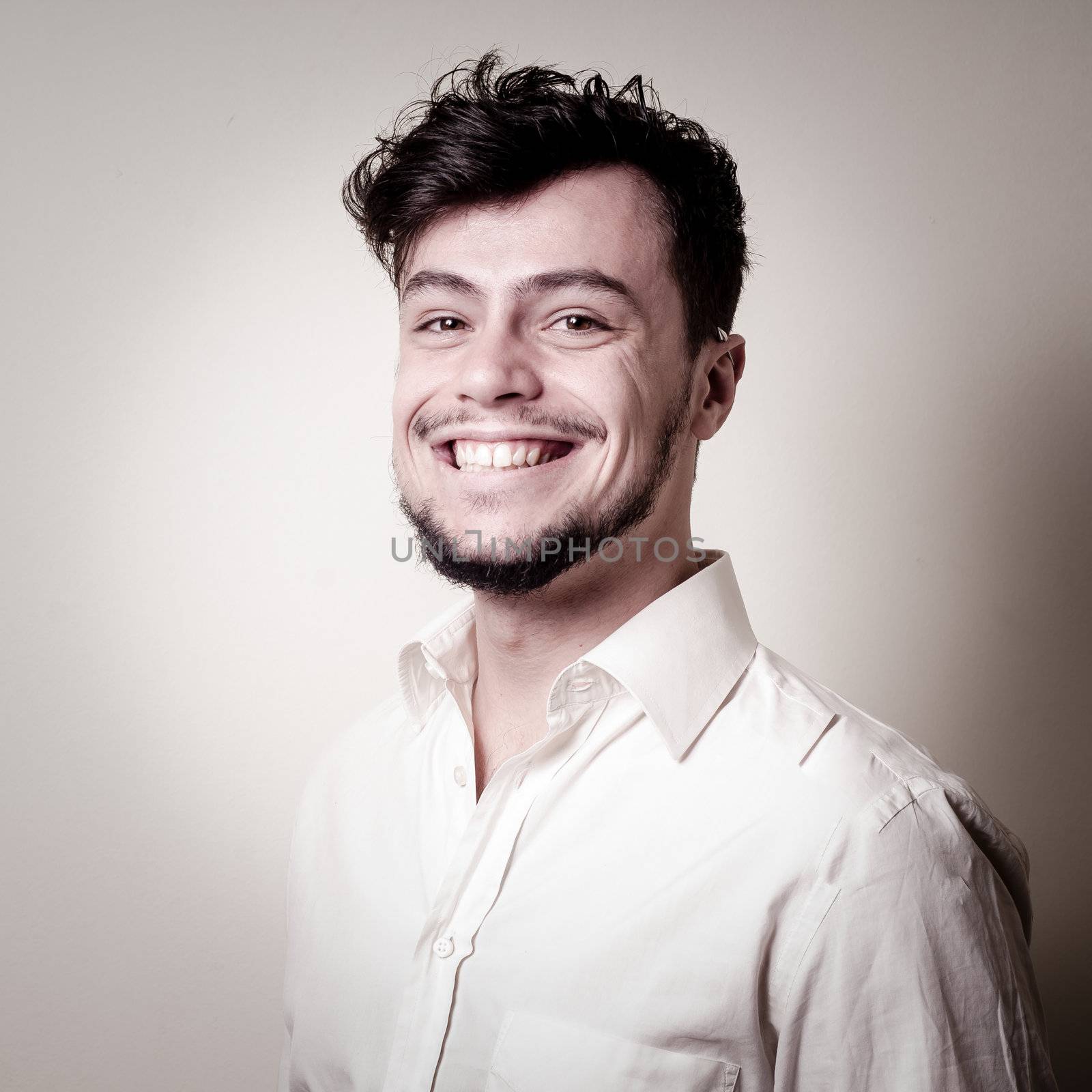 stylish modern guy with white shirt on gray background