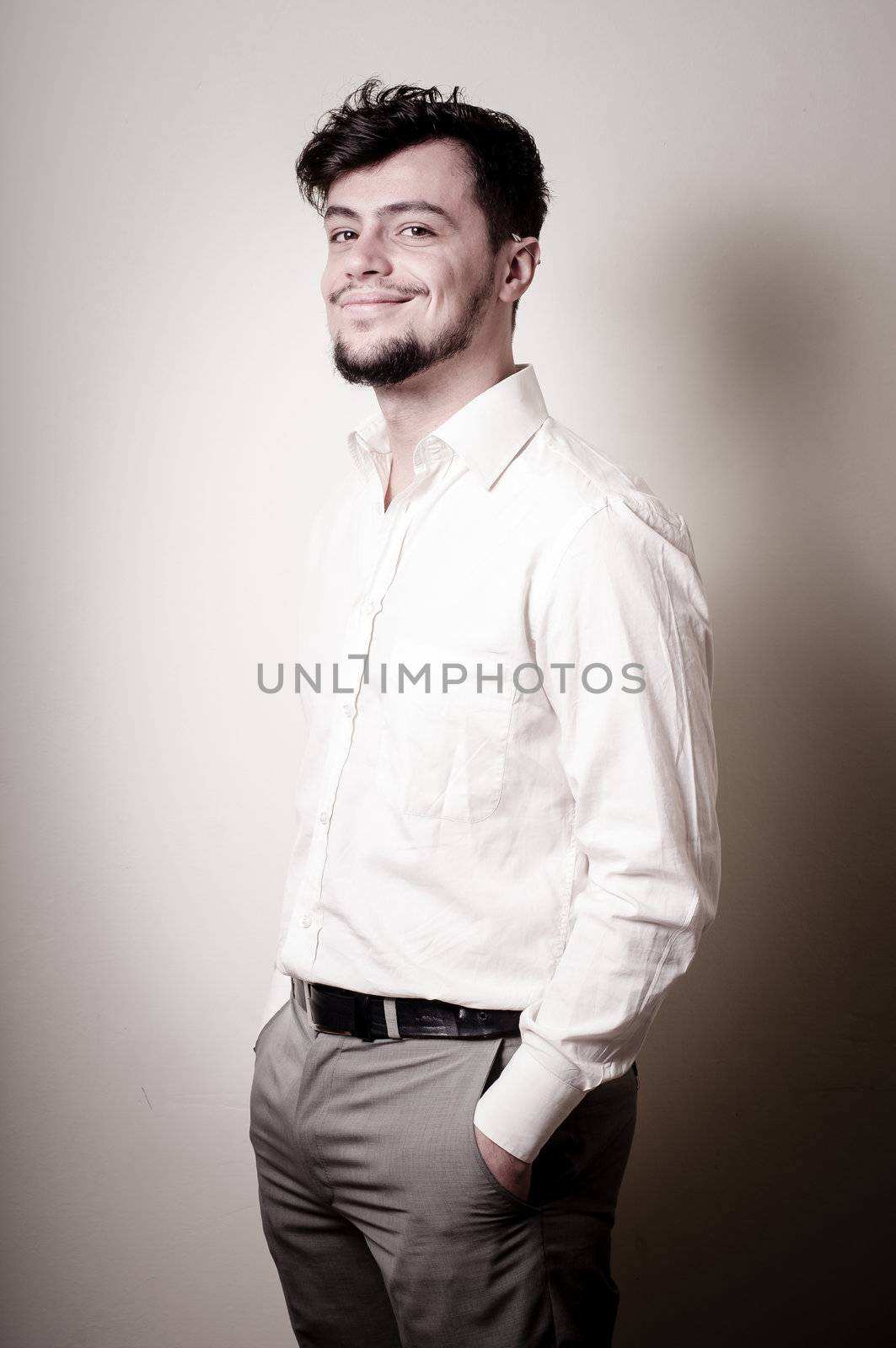 stylish modern guy with white shirt on gray background