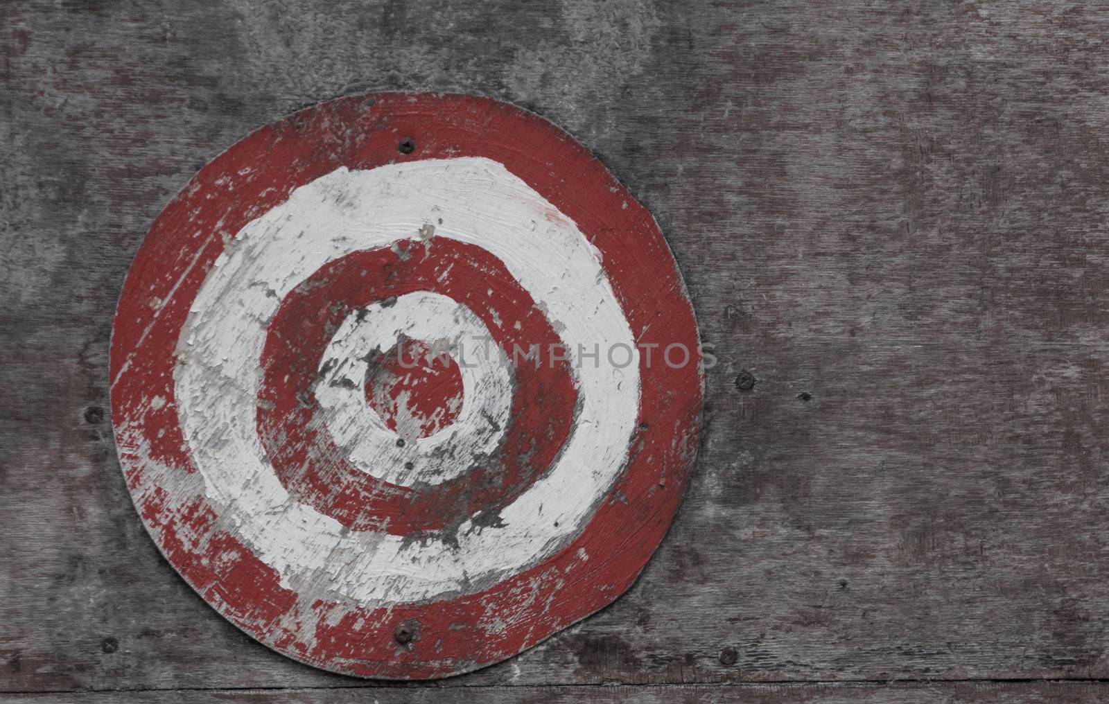 Picture of a red and white target on a wooden board