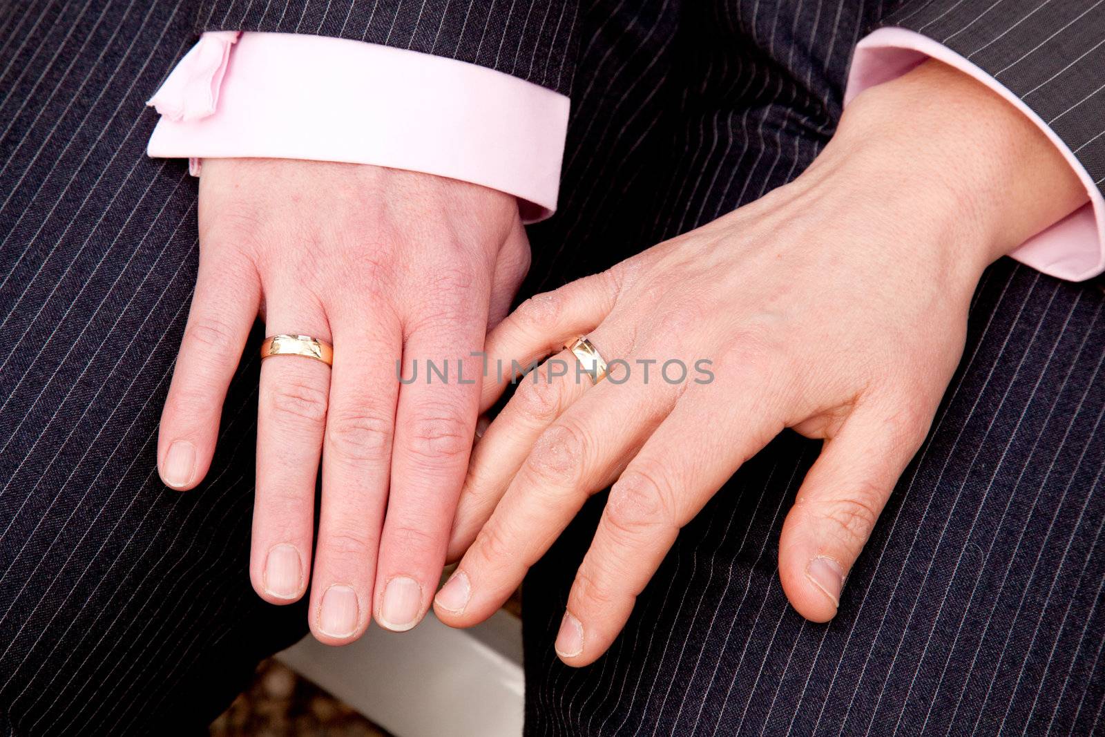 two female hands with wedding rings on homosexual wedding