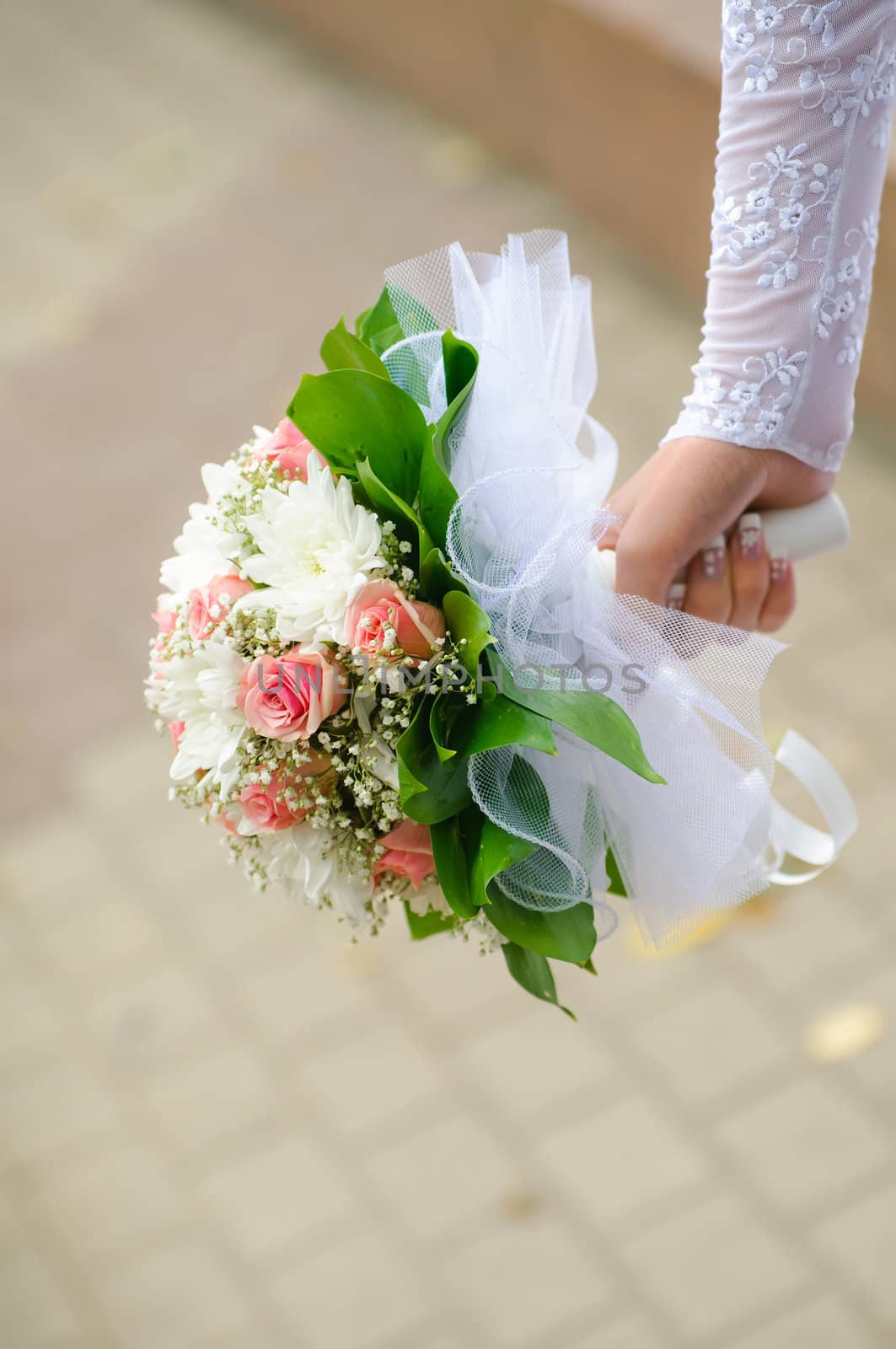 Wedding bouquet in hands of the bride. Blur background. 
