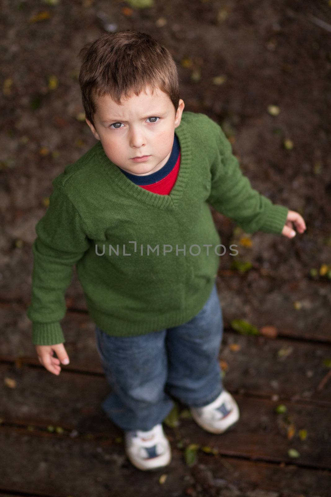 Young boy looking up and frowning