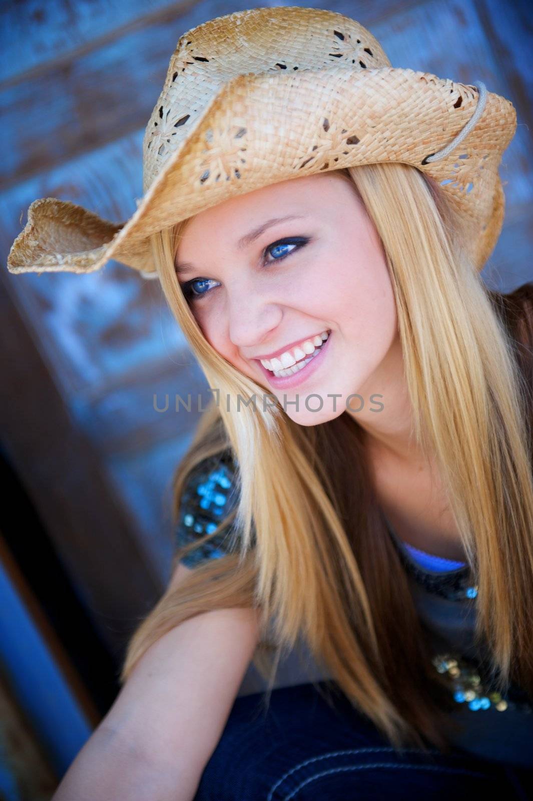 Attractive Blond Model Smiles While Wearing a Tattered Old Cowboy Hat