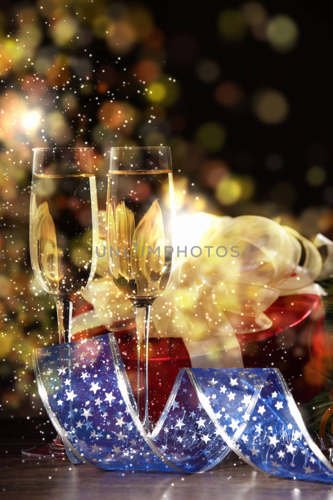 New Year's collage with glasses of champagne. Decorations and ribbons on a bright color background