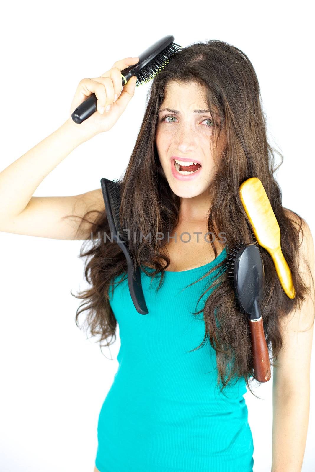 Woman stuck with brushes in her hair screaming loud, tangled hair