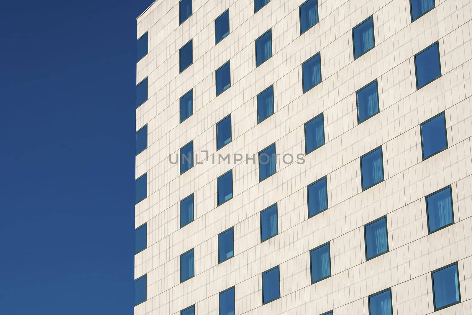 Modern public building wall,  blue windows as background