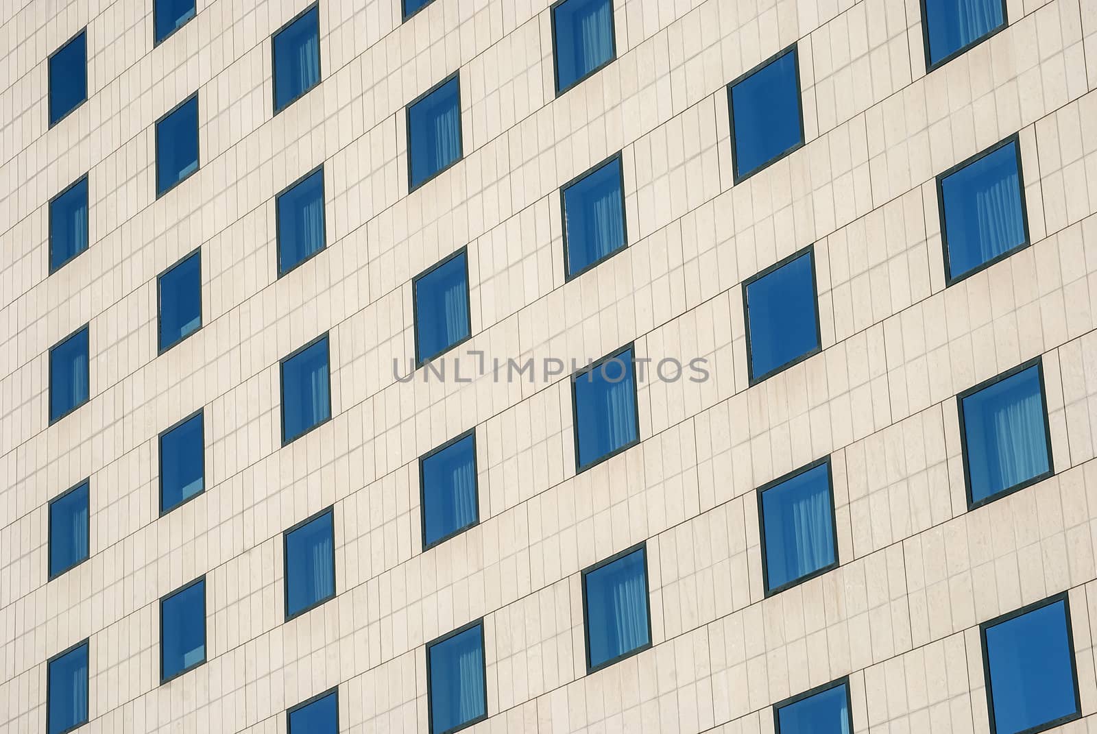 Modern public building wall,  blue windows as background