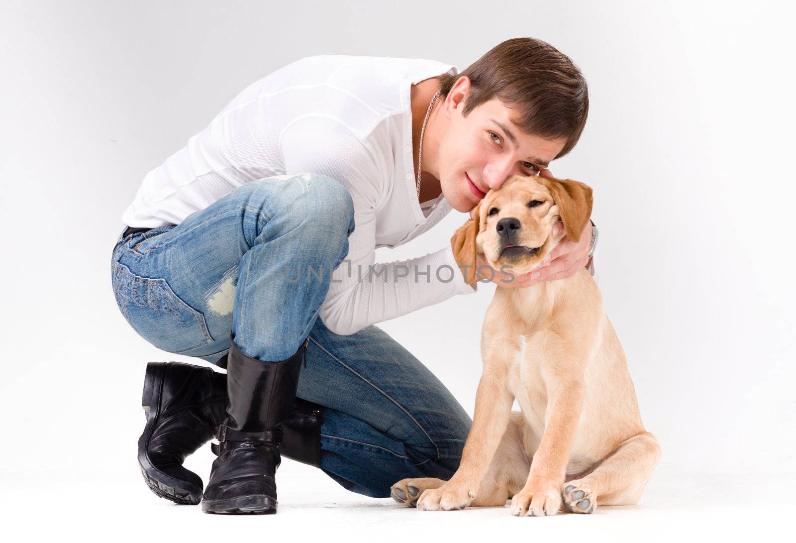 handsome man with dog over gray background