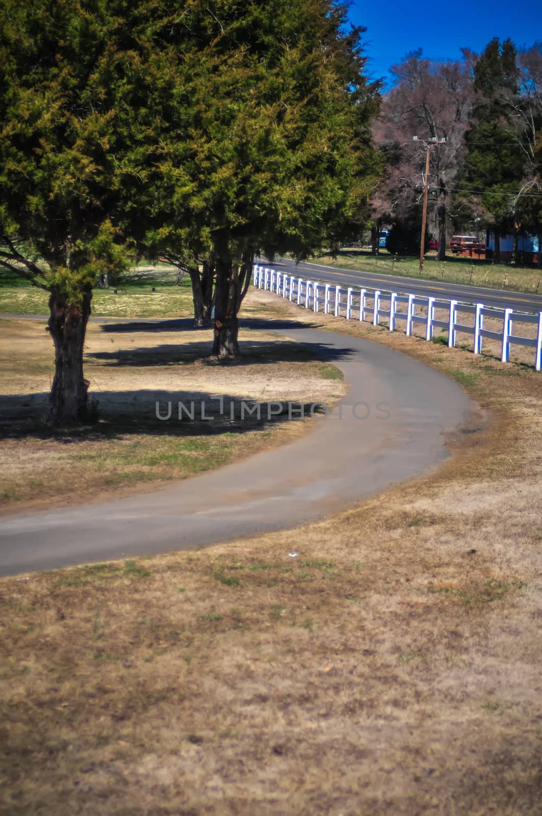country sidewalk with white fence