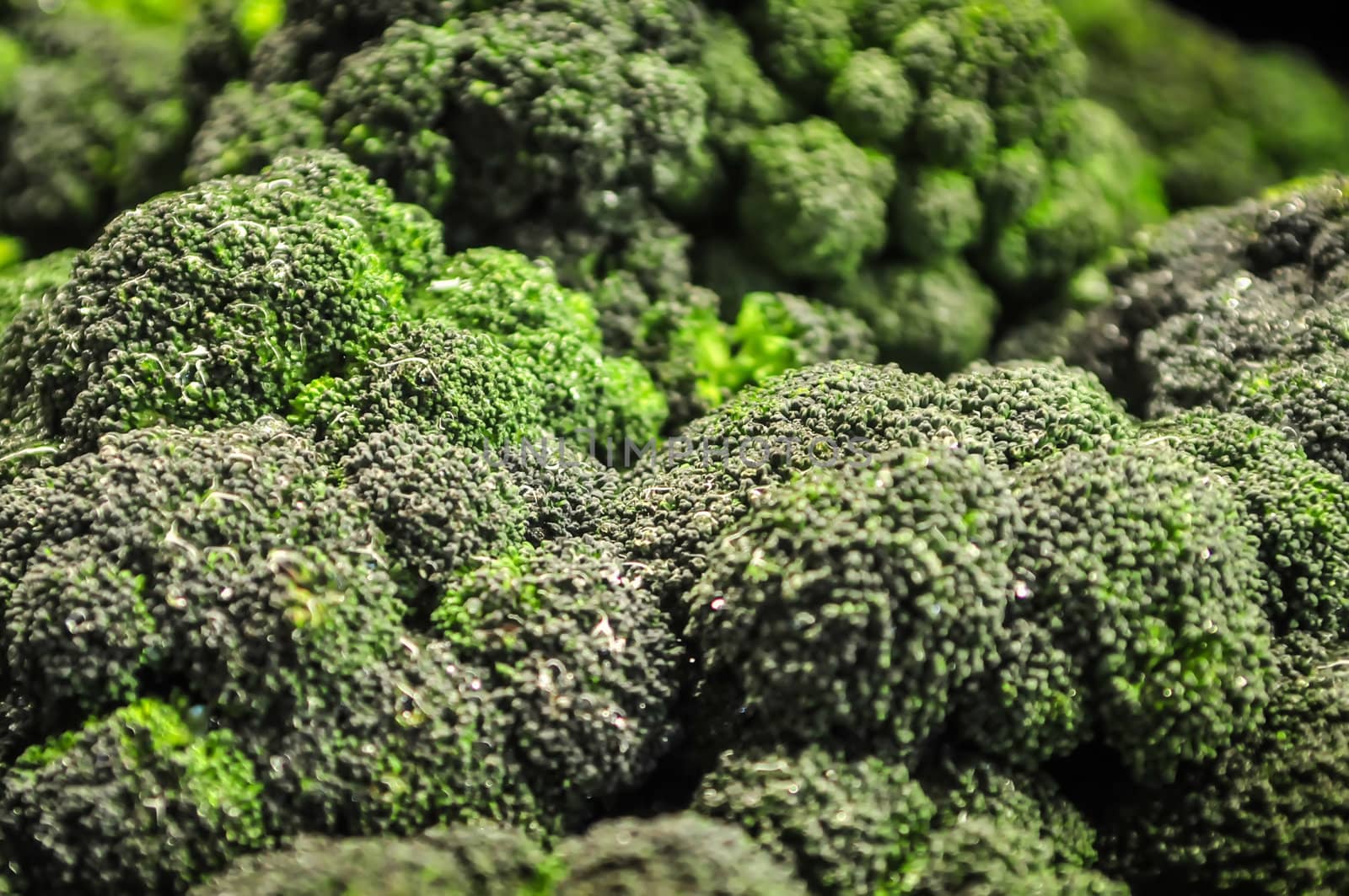 Broccoli in a pile on a farm stand by digidreamgrafix