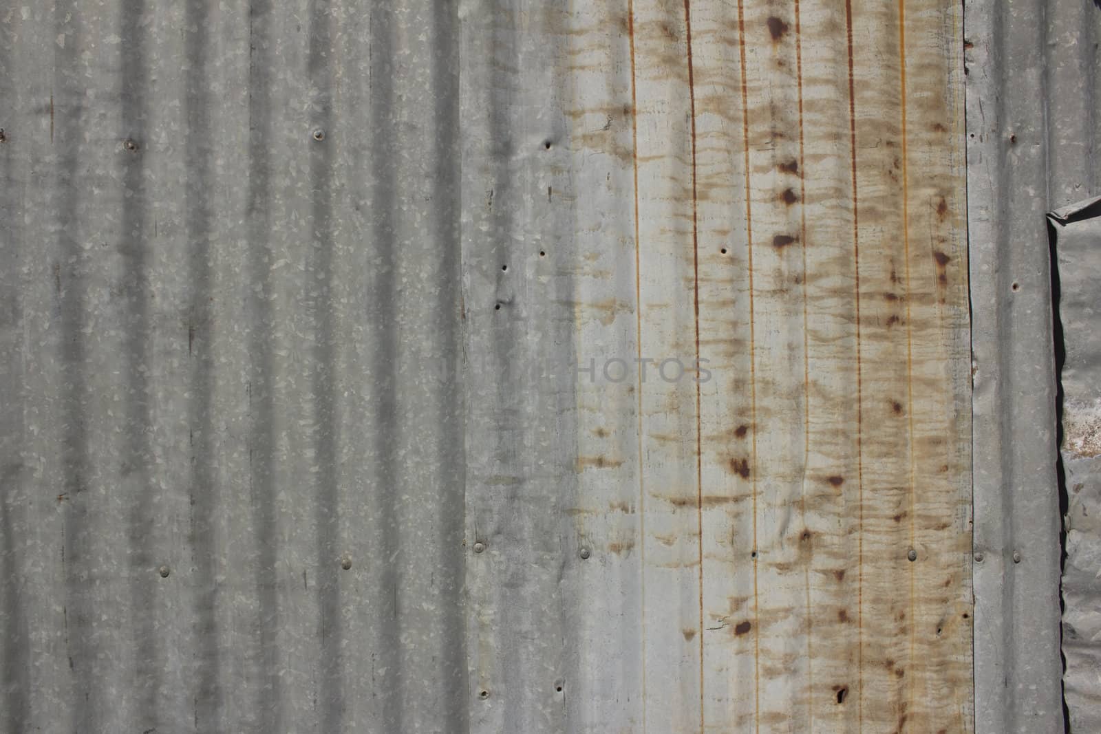 A rusty corrugated iron metal fence close up/ Zinc wall