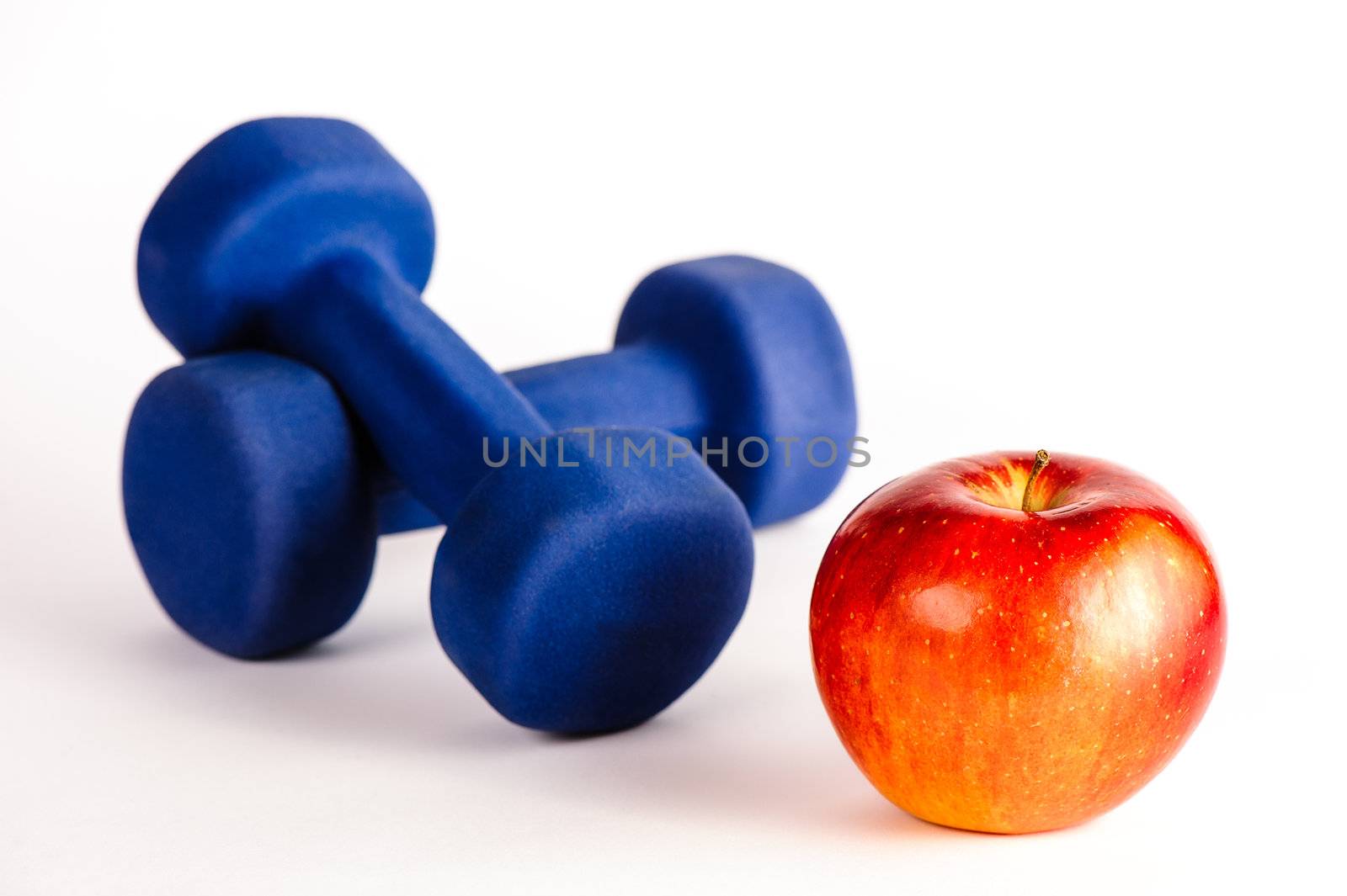 Blue dumbbells and red apple by nvelichko