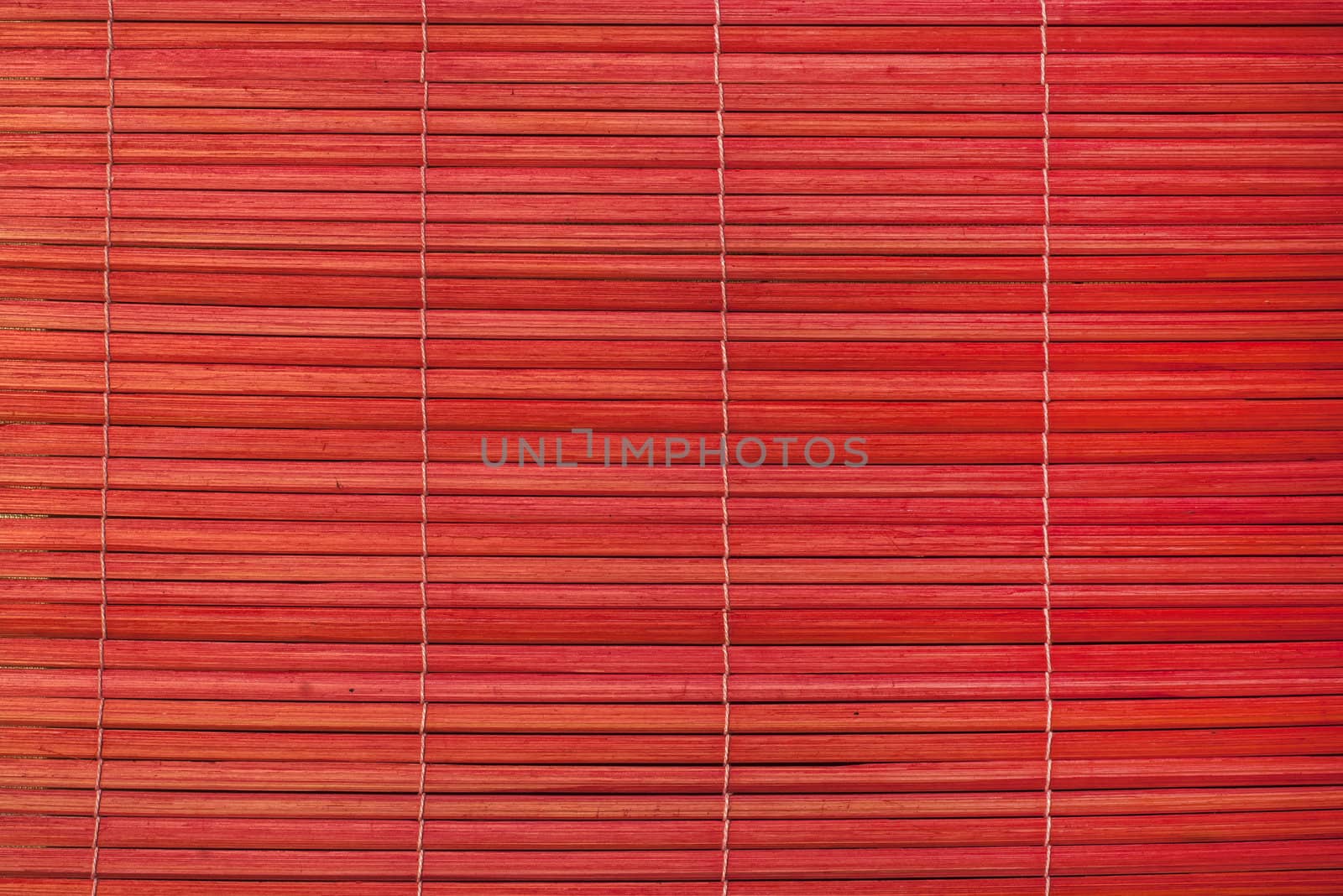 Red reed mat texture closeup as background